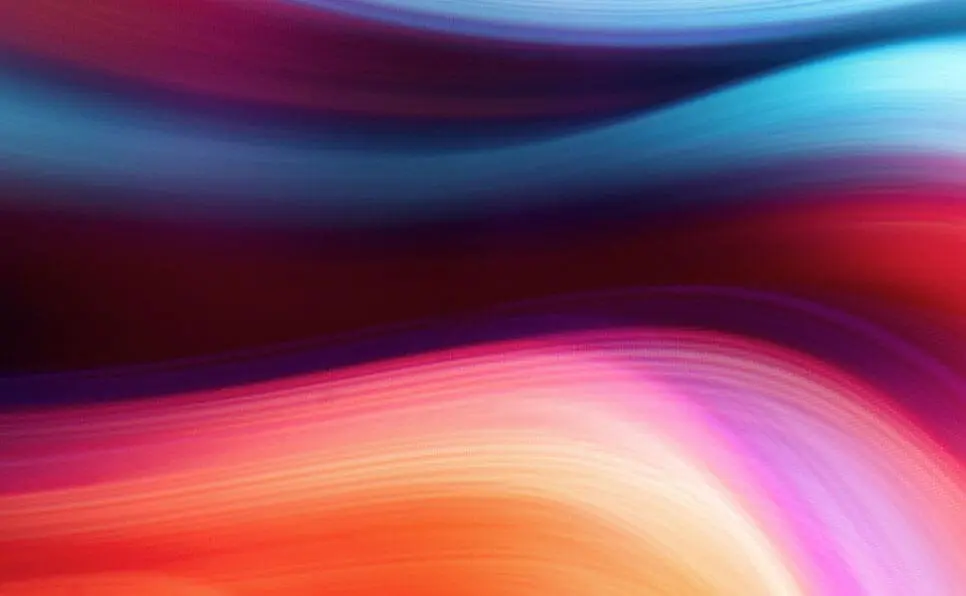 Colorful abstract image with smooth, wavy lines in shades of blue, purple, red, pink, and orange, blending together in a soft, flowing motion. No distinct objects or shapes are visible.